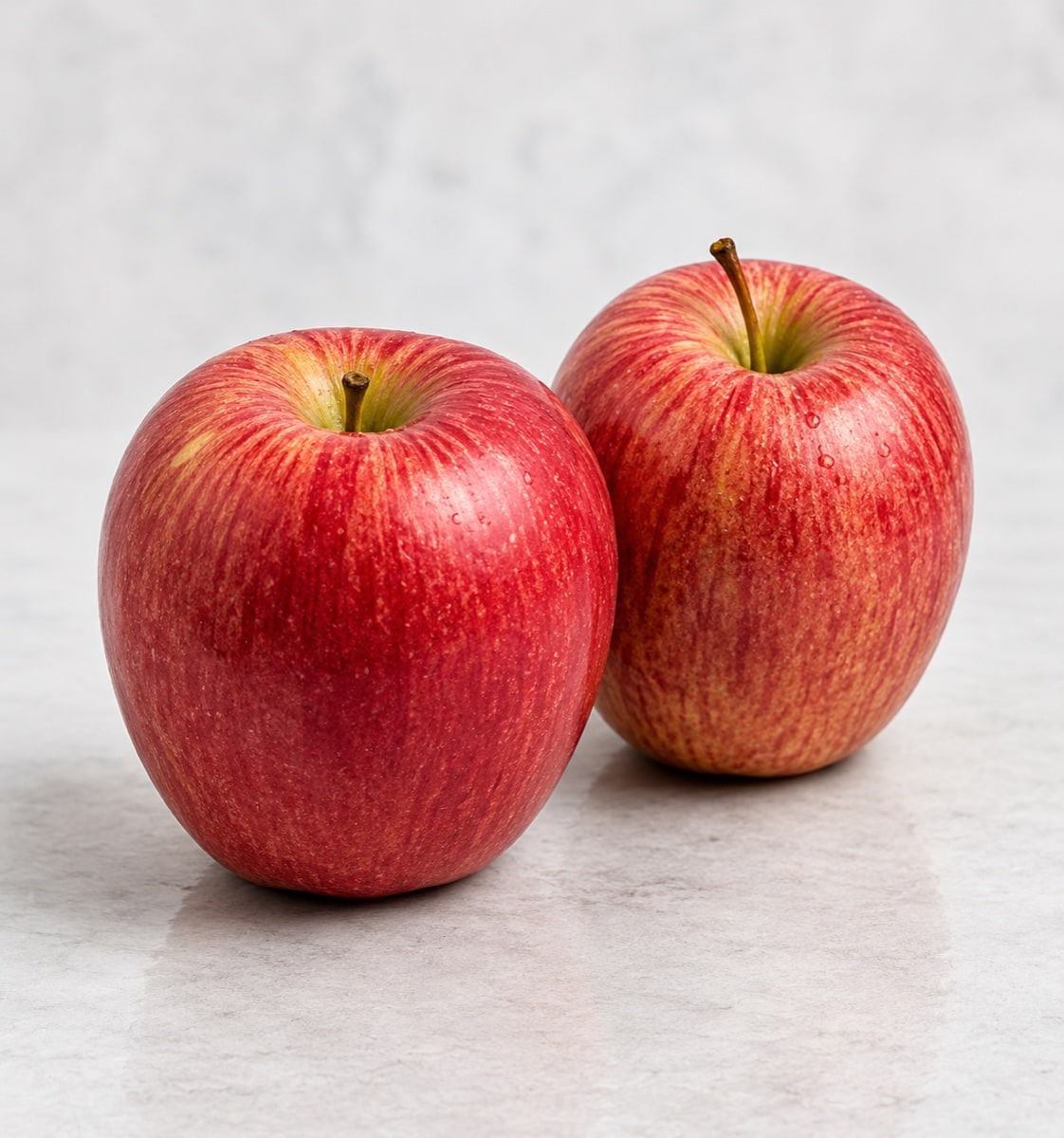 Two fresh red Shimla apples